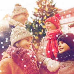 happy family over city christmas tree and snow